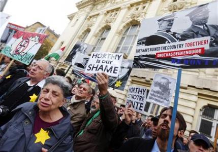 Hungarian opposition activists protest against the erection of a statue of wartime leader Miklos Horthy in central Budapest