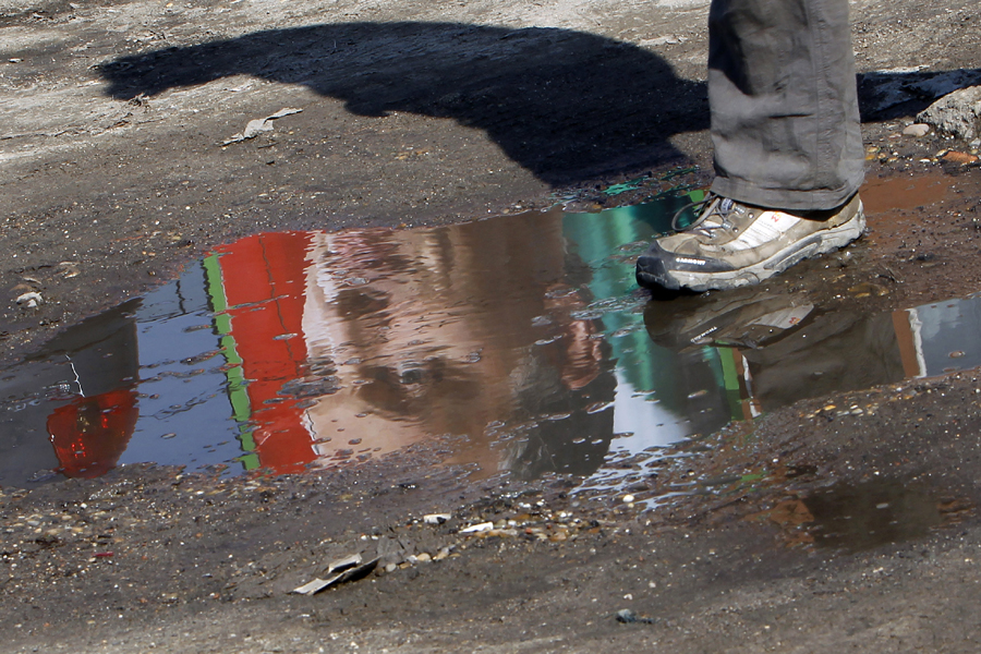 An election poster of Viktor Orban, leader of Hungarian opposition party Fidesz, is reflected in a puddle of water in central Budapest
